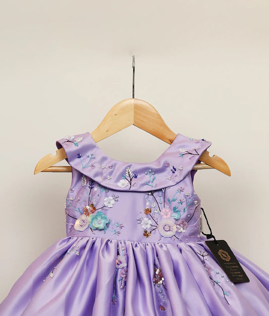 Close view of lavender flower-themed dress against white background