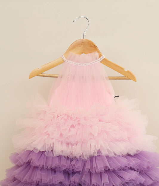 Close view of multi-color tulle net handworked step gown against plain background