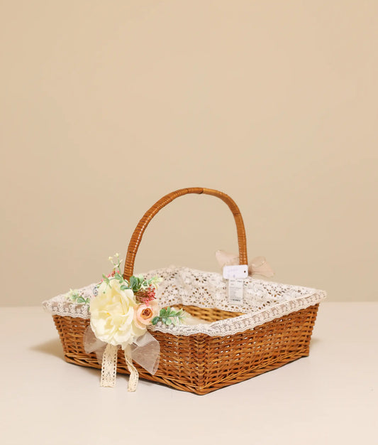 Off-white and peach flower baptism wicker basket against plain background