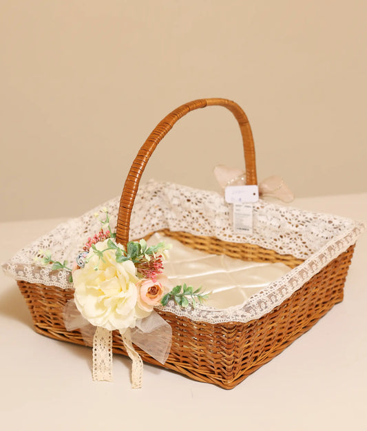 Close view of off-white and peach flower baptism wicker basket against plain background