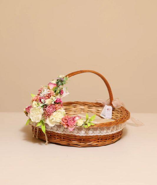 Close view of pink and off-white flower baptism wicker basket against plain background
