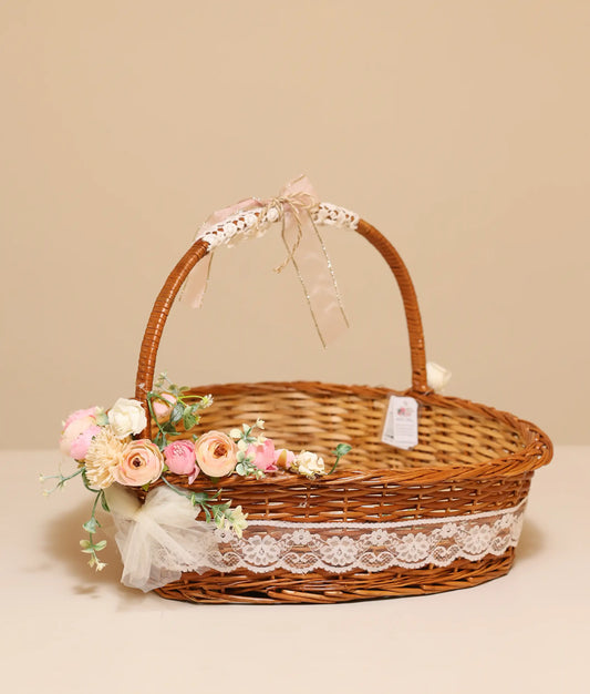 Off-white, pink, and peach flower baptism wicker basket in plain background