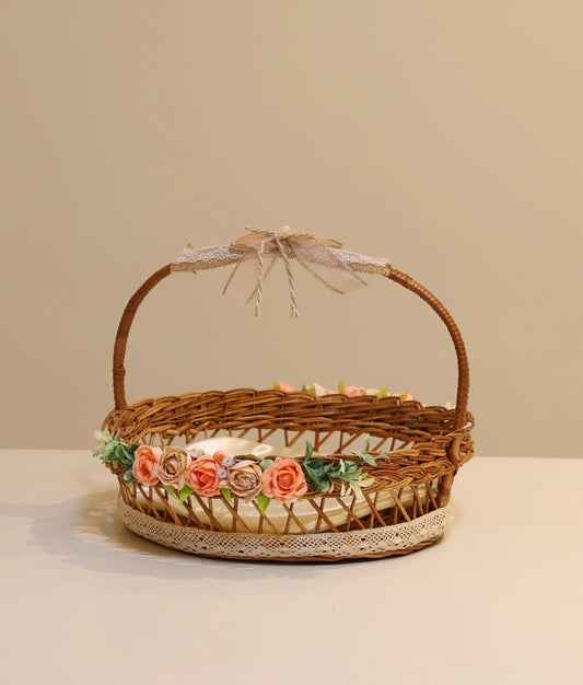 Pink and beige decorative flower wicker baptism basket against plain backround