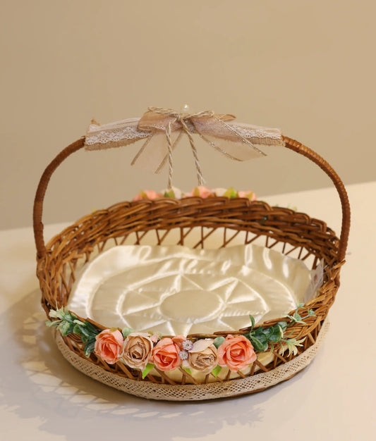 Pink and beige decorative flower wicker baptism basket against plain background
