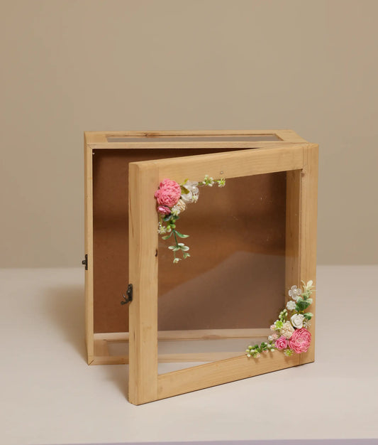 Pink and off-white decorative flower baptism wooden box against plain background
