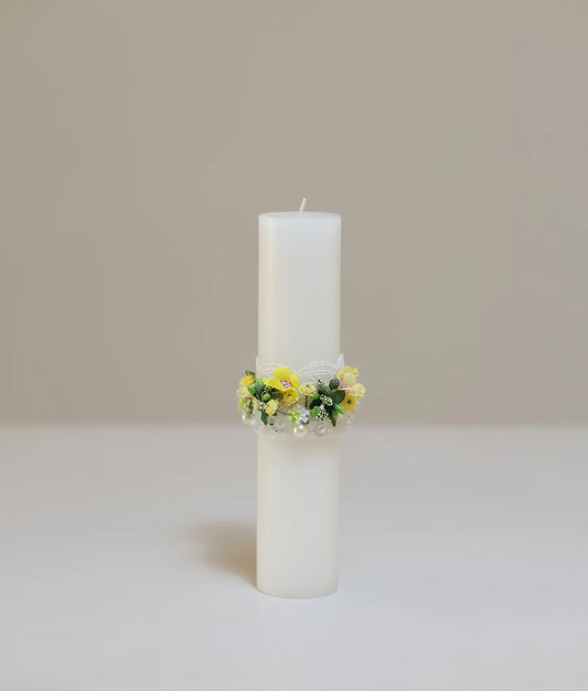 front view of a yellow floral flower pillar candle for your baby baptism