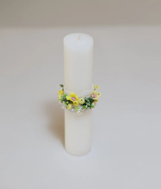 Close view of a yellow floral flower pillar candle for your baby baptism