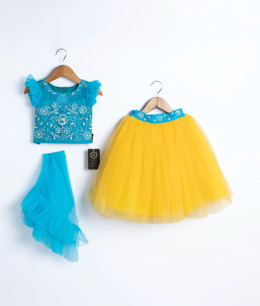 A blue tulle net handworked crop top, skirt and a dupatta in blue displayed on a hanger.