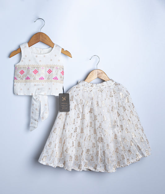 An off white Chanderi classic top with full-length skirt, displayed on hangers, featuring pink embroidery and pleated design.