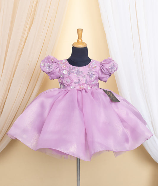 Lavender dress on a mannequin against a beige curtain background.