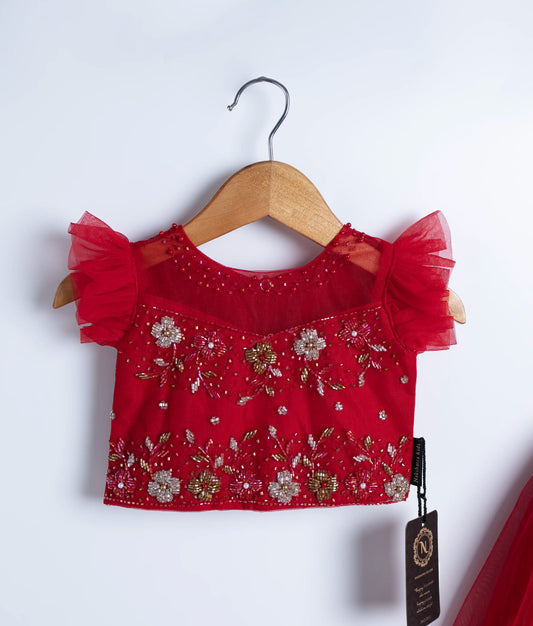 Close view of an red tulle net handworked crop top displayed on hangers against a white background.