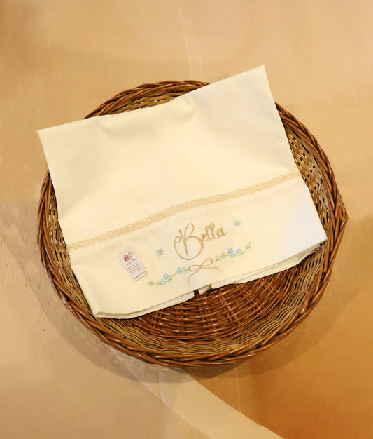 Front view of an off-white embroidery baptism towel with customized name.