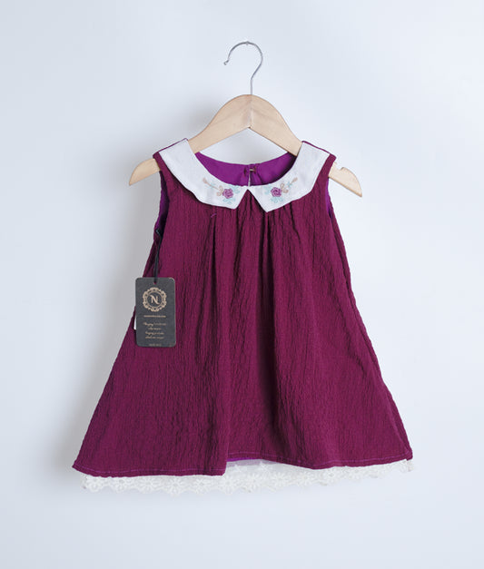 A grape wine sleeveless frock displayed on a hanger.