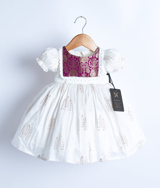 An off-white short-sleeved frock displayed on a hanger.