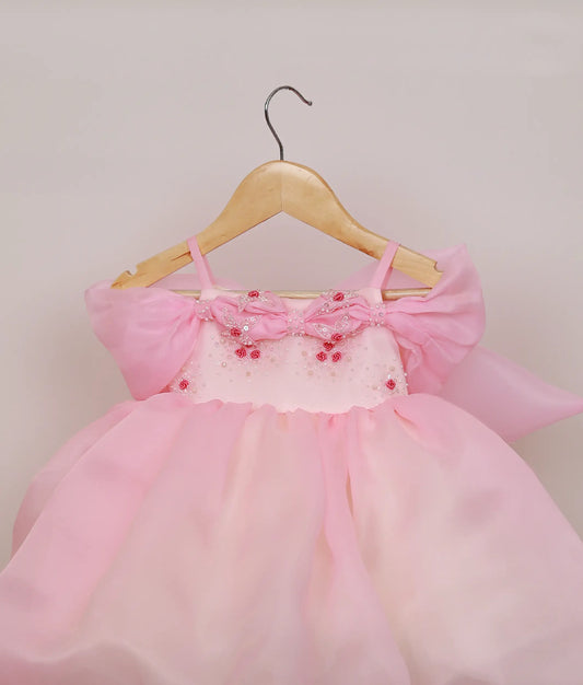 Close view of an pink plain organza handworked high-low birthday frock