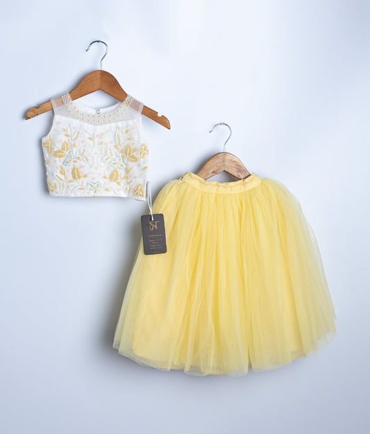 Yellow baby girl ceremonial dress with floral top and tulle skirt on hanger
