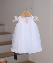 Front view of elegant handworked baptism set for baby girls.