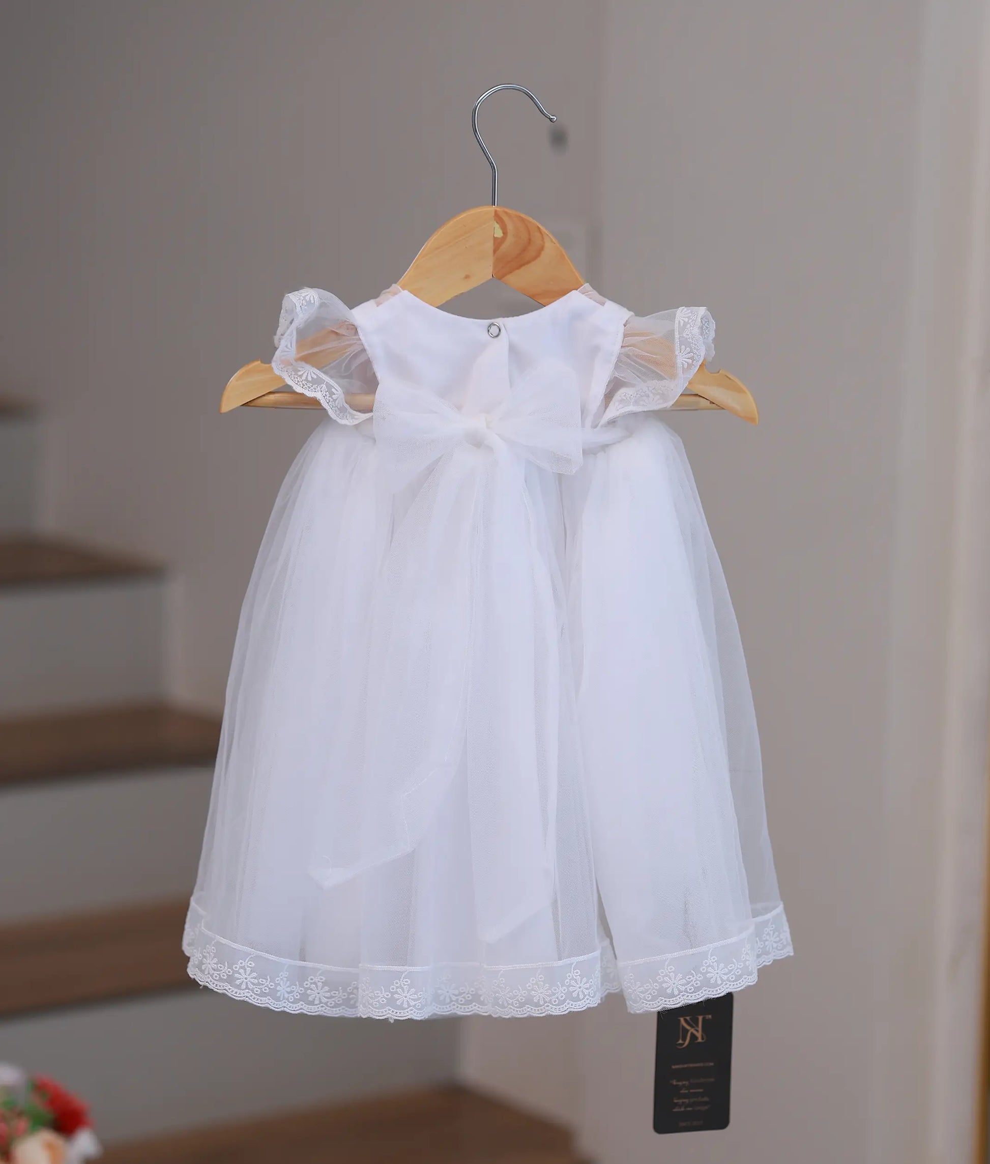 Back view of style 2873 baptism dress showing the high-quality finish and secure closure for a baby ceremony outfit.