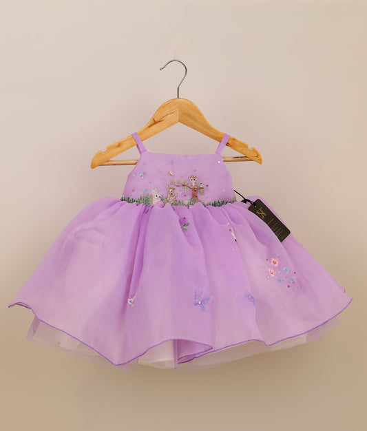 Front view of an lavender plain organza jungle-themed birthday frock against plain background 