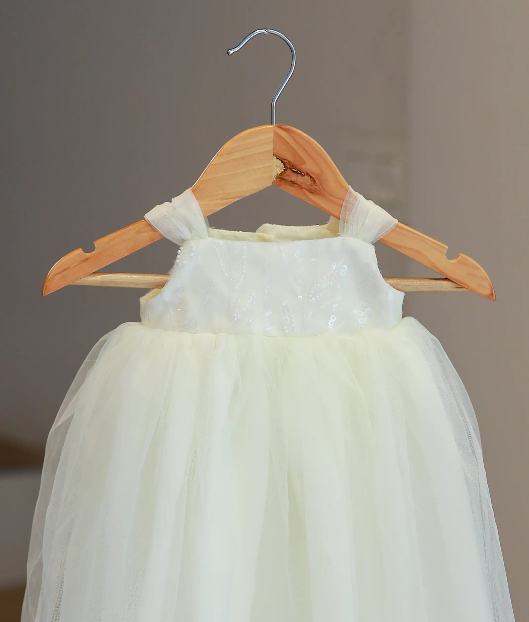 Close-up of intricate hand-stitched floral embroidery and beadwork on the bodice of style 5585 baptism gown.