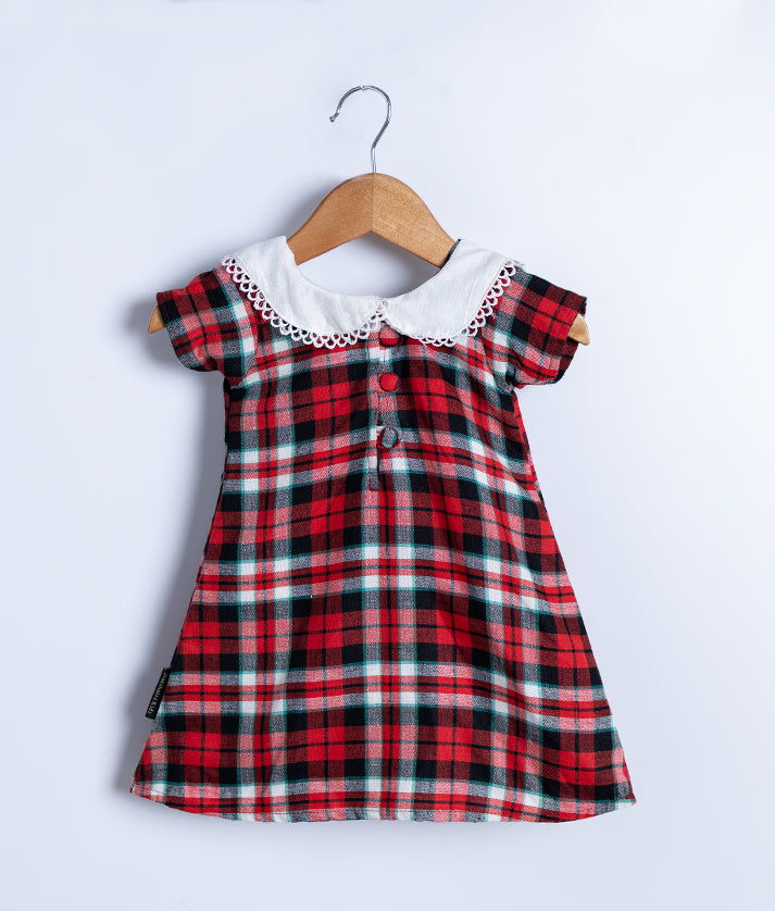 Back view of an red and black checkered cotton frock displayed on a hanger.