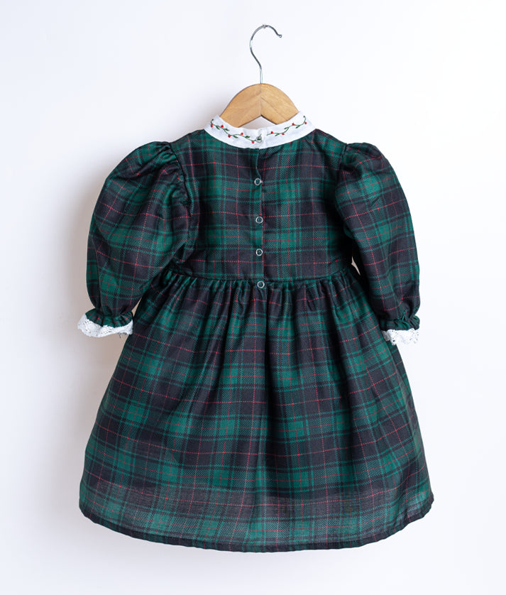 Back view of an black and green checkered cotton frock displayed on a hanger.