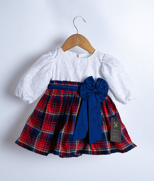 A red and white checked cotton christmas frock displayed on a white background.