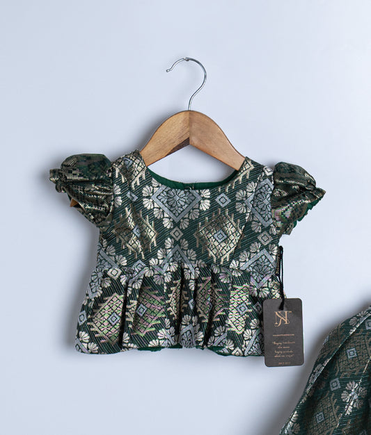 Kids traditional outfit with a dark green brocade peplum top and matching flared skirt, both featuring intricate gold and silver woven patterns