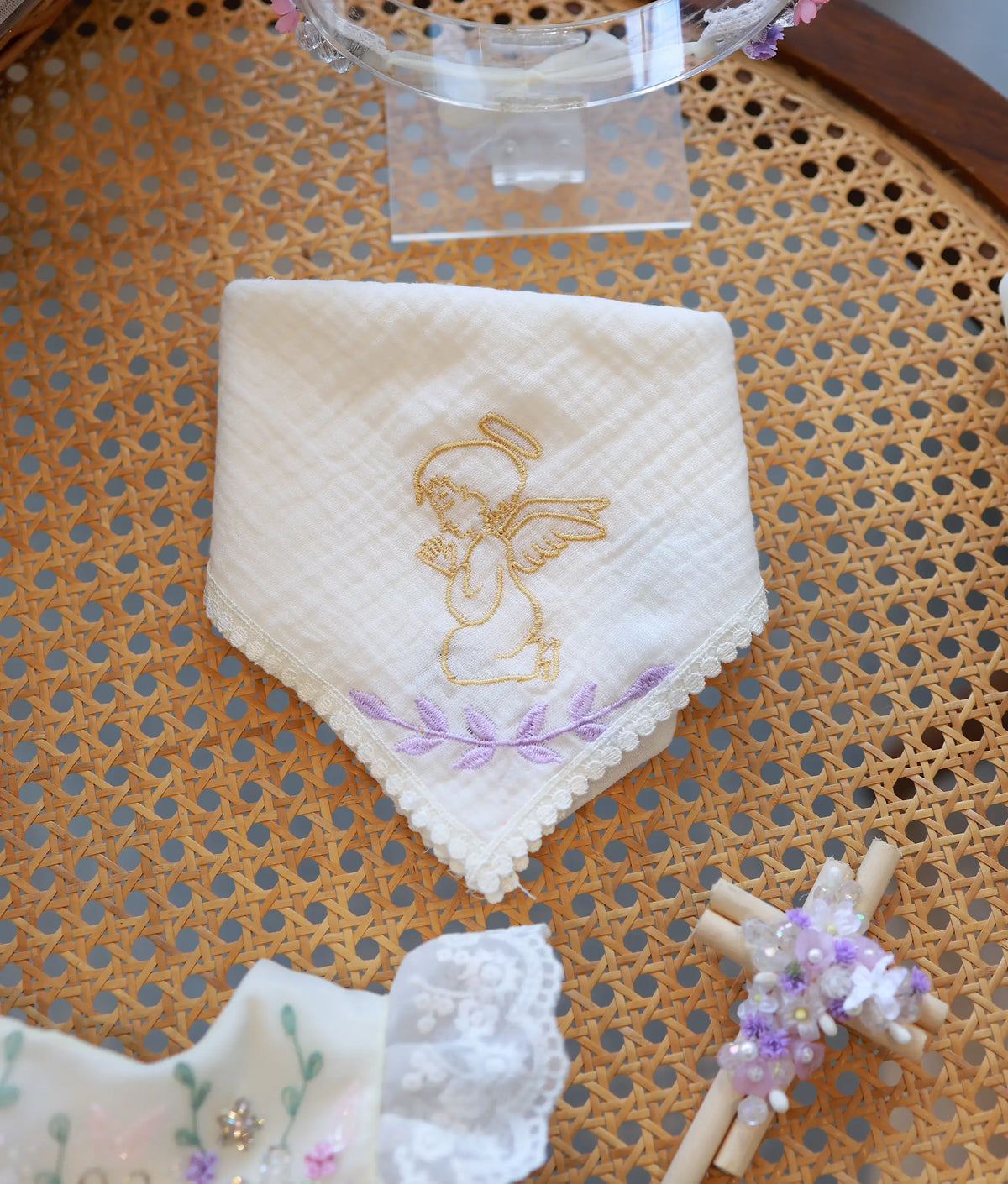 Off-white handkerchief featuring an embroidered praying angel design with delicate lace borders.