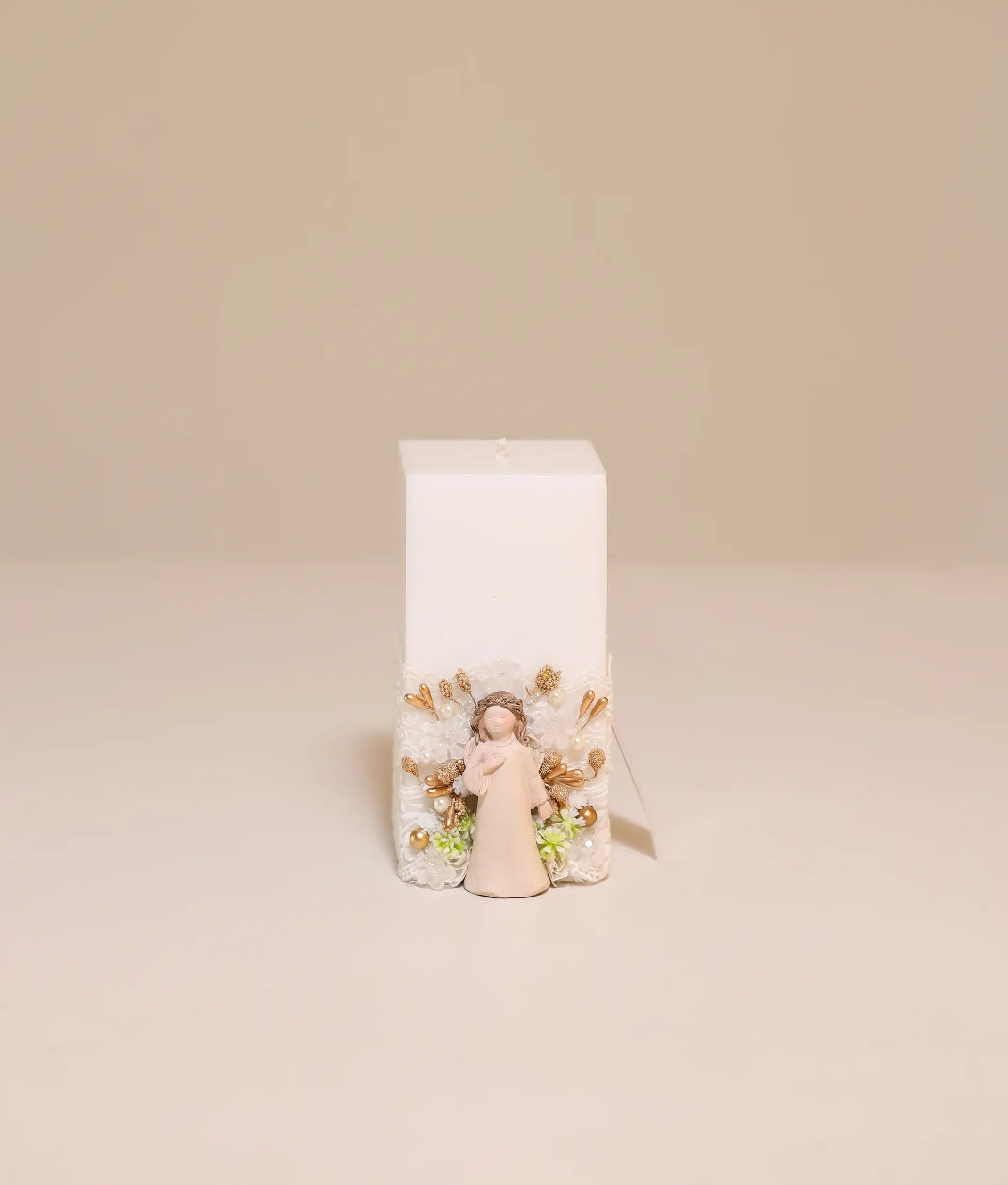 Elegant baptism candle with angel theme, featuring white lace, ribbon ruffles, and gold pearl accents
