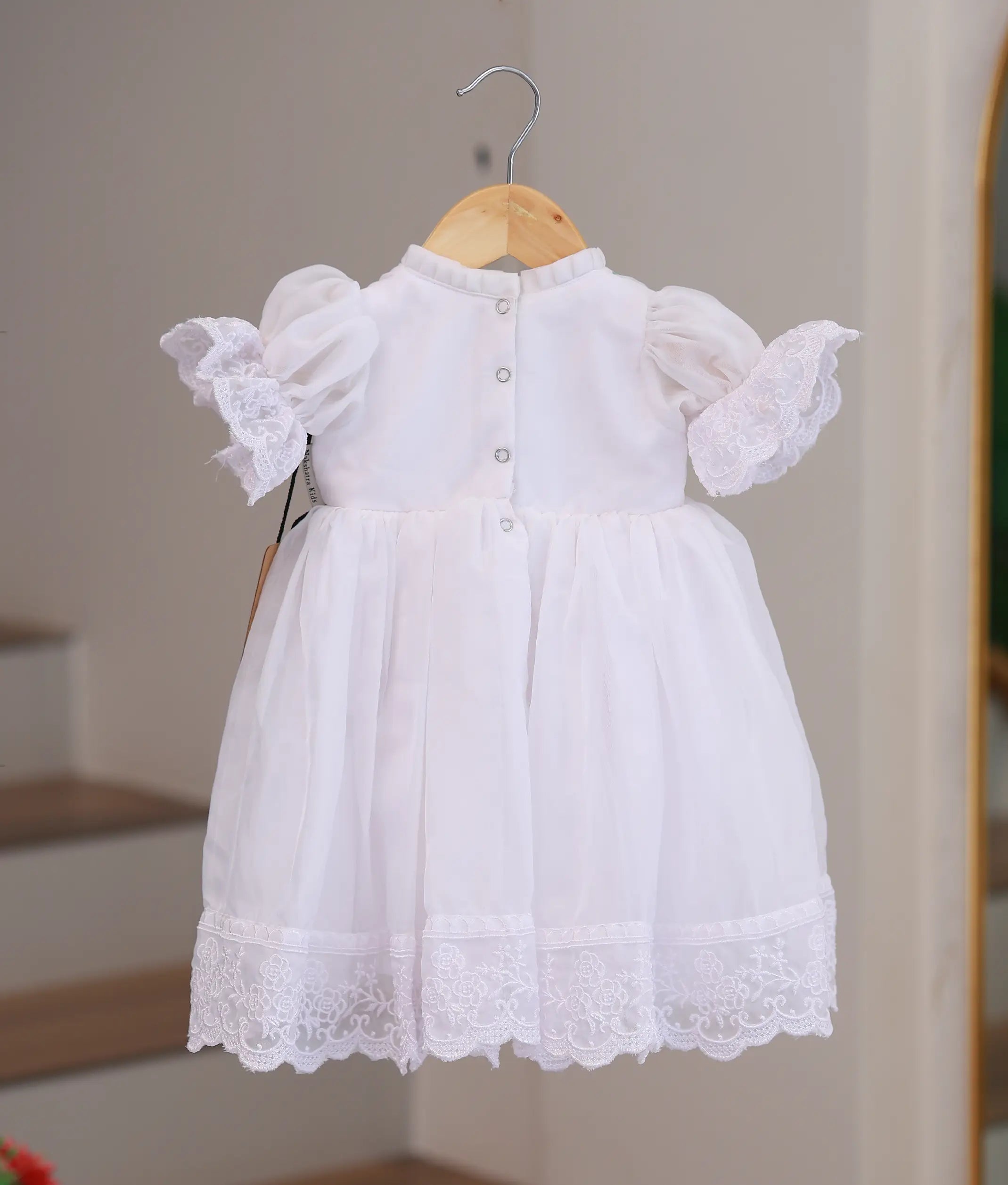 Back view of style 2476 baptism frock showing the high-quality finish and secure closure for a baby ceremony outfit.