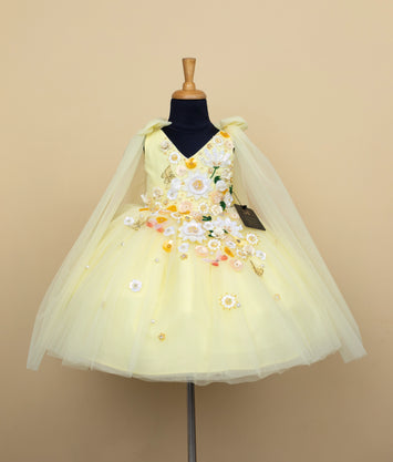 Baby girl cream colored formal dress with floral embroidery and tulle skirt on dress form mannequin