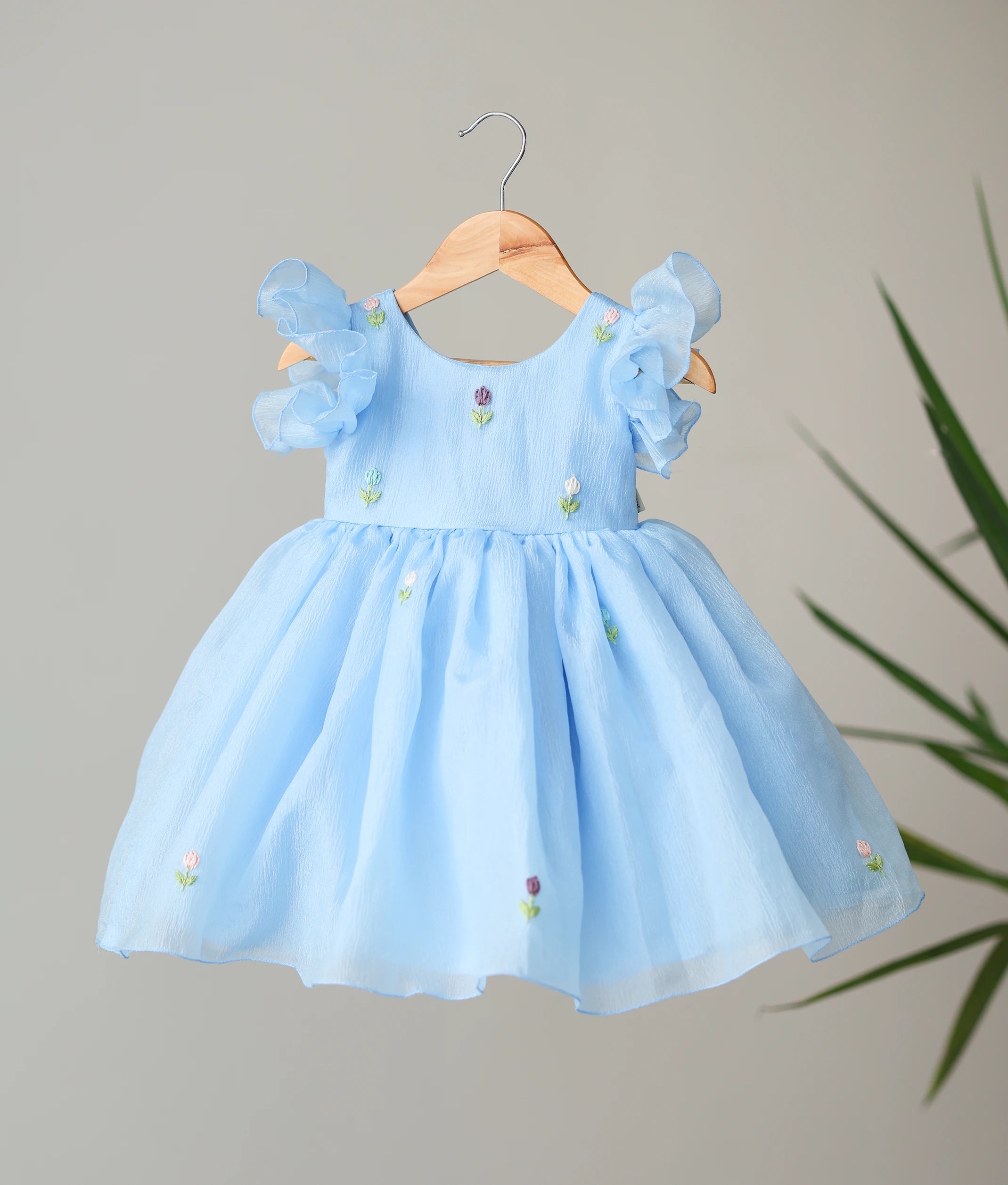 Front view of a pastel blue floral handworked crush organza birthday dress for baby girls featuring layered butterfly sleeves and a flared skirt