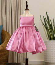 Front view of a pink rafaella elegant birthday frock for baby girls featuring a sleeveless square-neck bodice and a full flared skirt