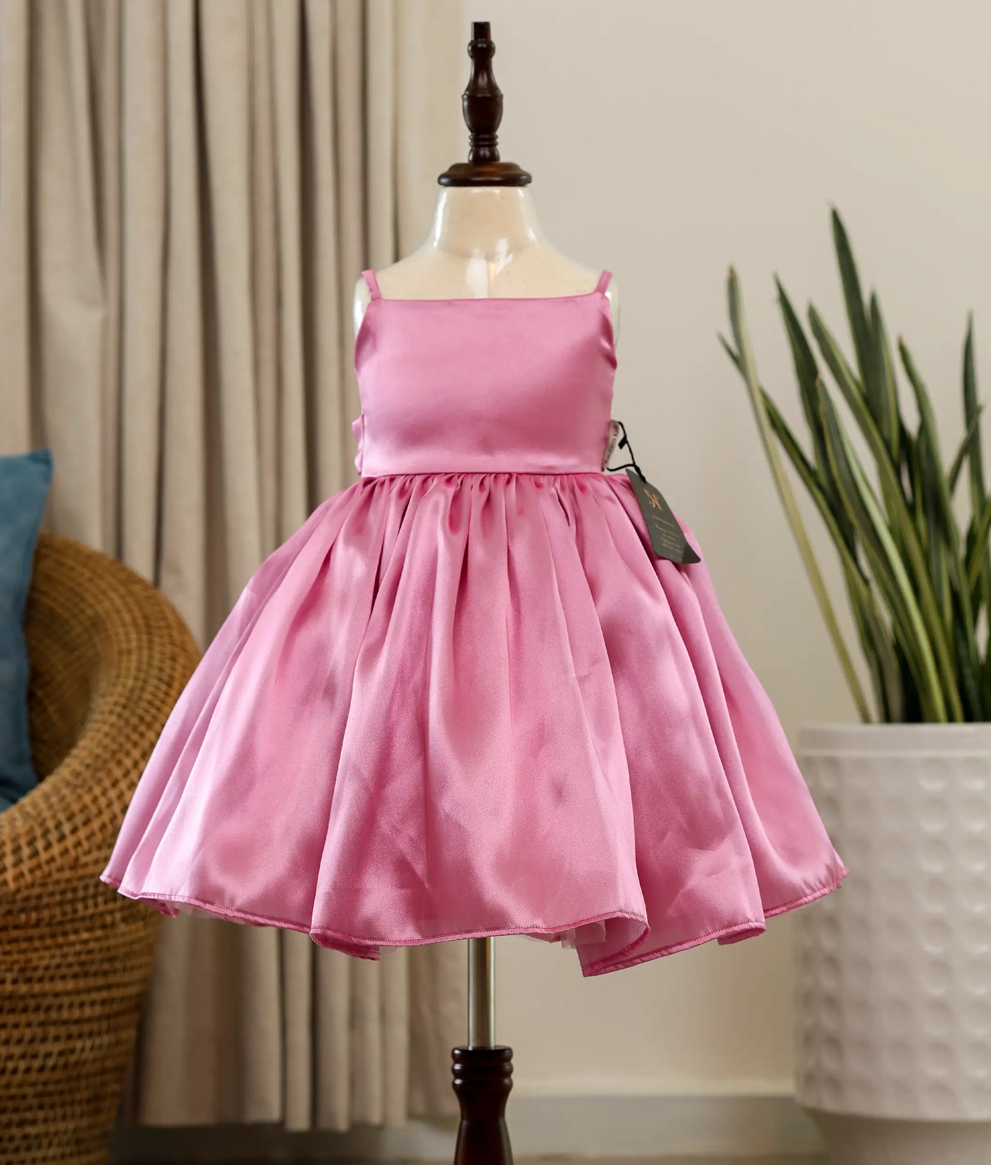 Front view of a pink rafaella elegant birthday frock for baby girls featuring a sleeveless square-neck bodice and a full flared skirt