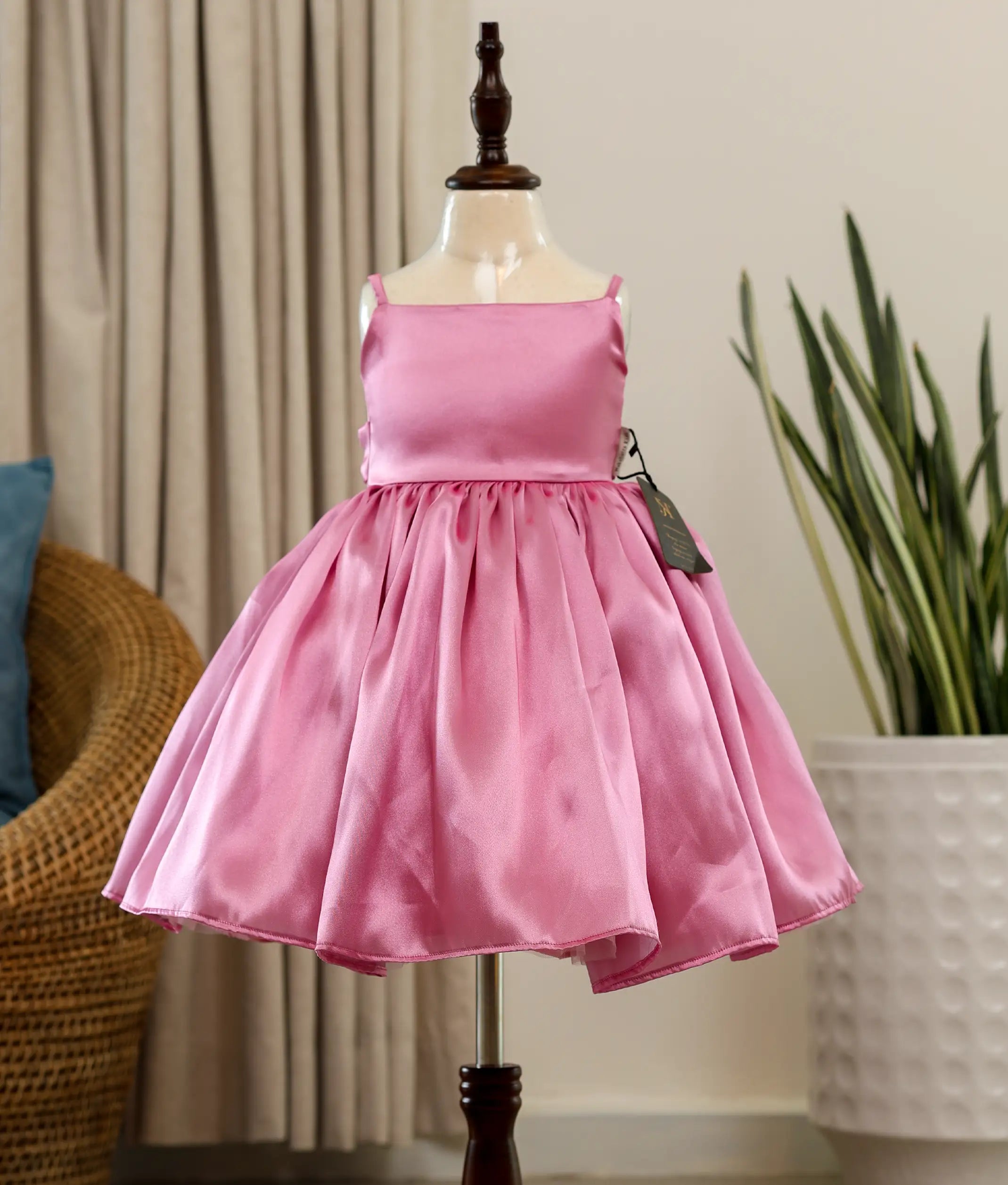 Front view of a pink rafaella elegant birthday frock for baby girls featuring a sleeveless square-neck bodice and a full flared skirt