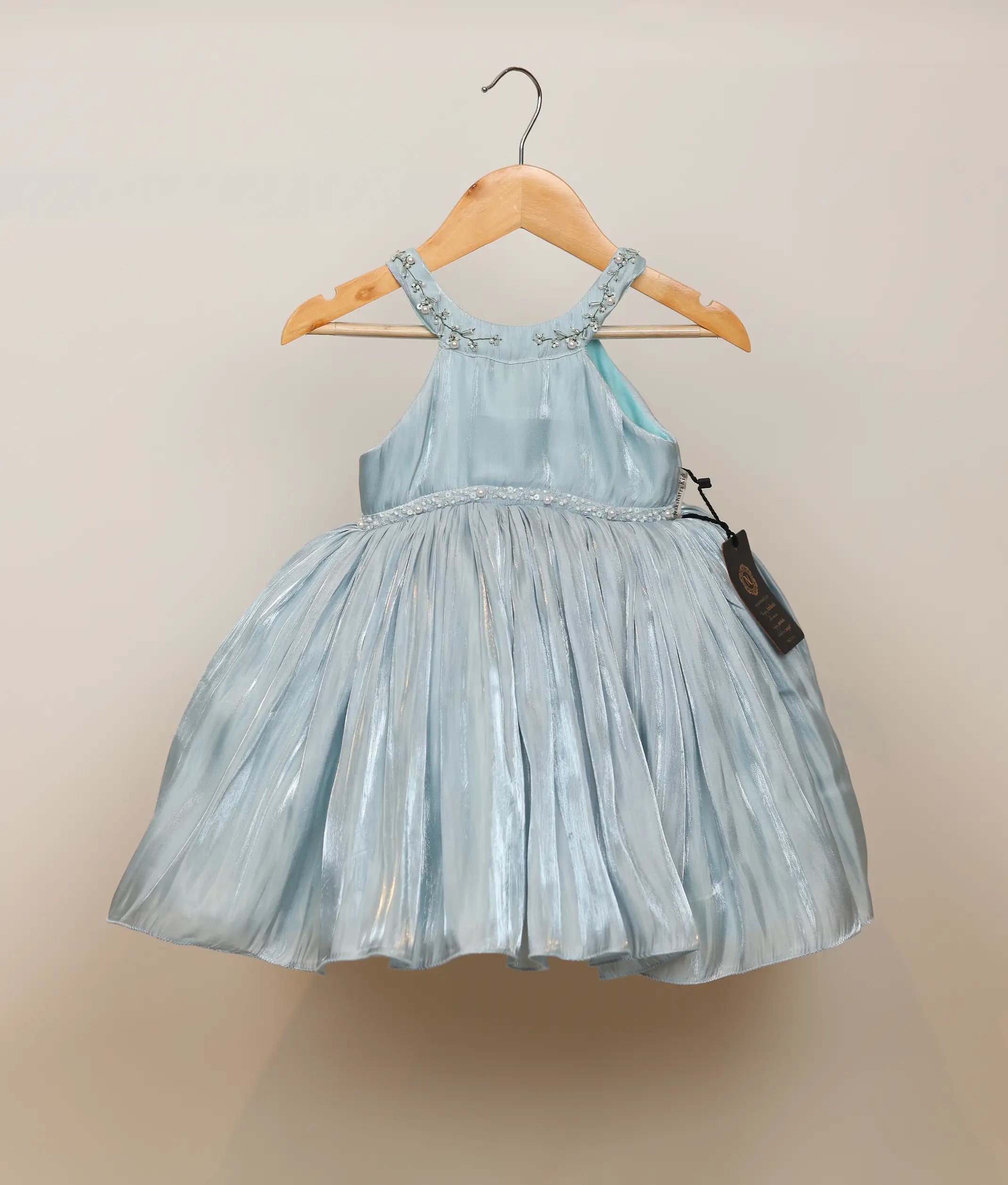 Front view of a powder blue lacer organza handworked birthday frock for baby girls featuring a beaded collar and flared skirt
