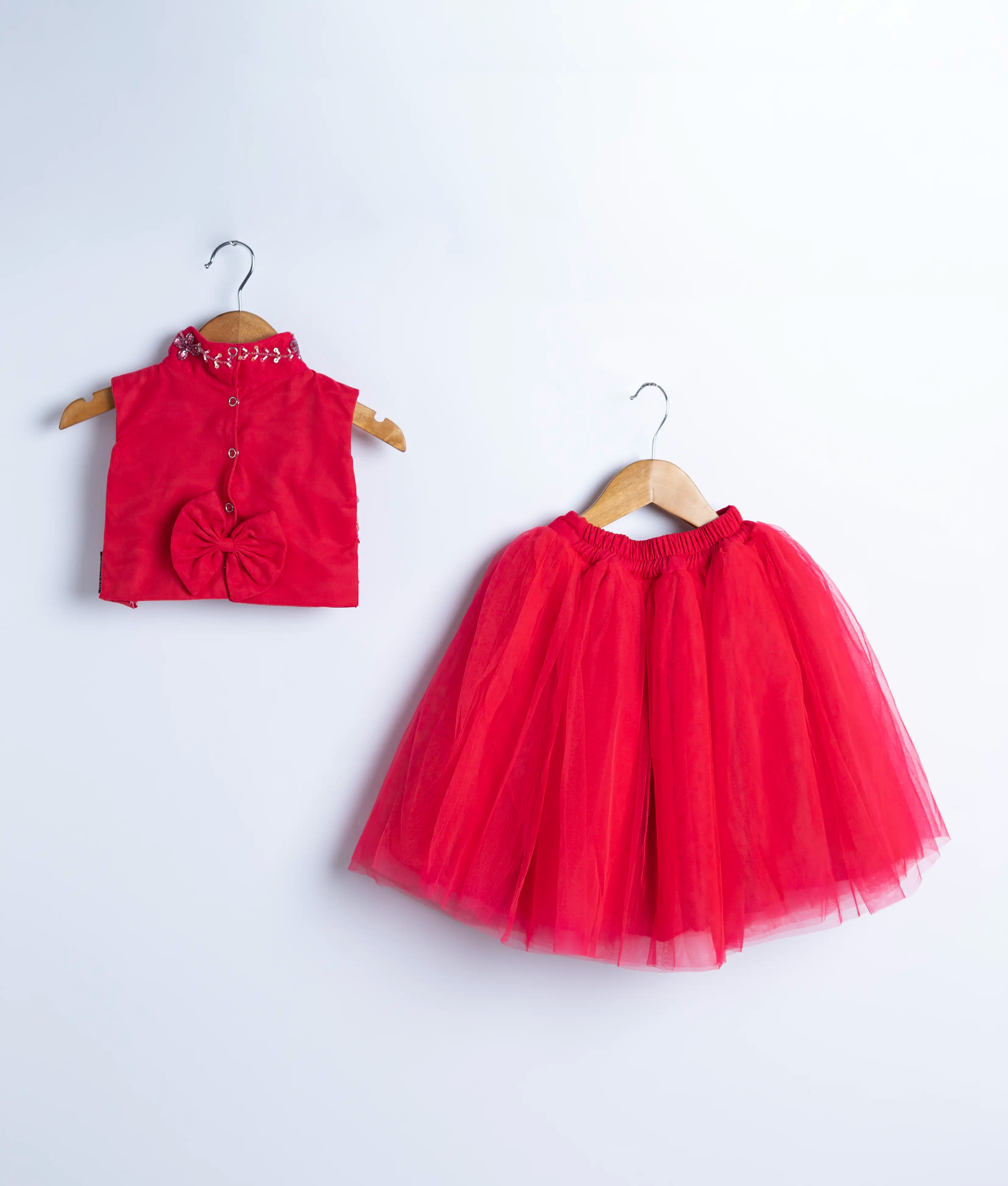Front view of red baby girl party dress with sleeveless floral top and net skirt – toddler fashion set