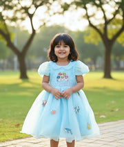 Baby girl wearing a sky blue Baby Shark theme birthday dress for girls with handworked characters and sea animals