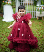 Baby girl wearing maroon handworked butterfly theme birthday gown