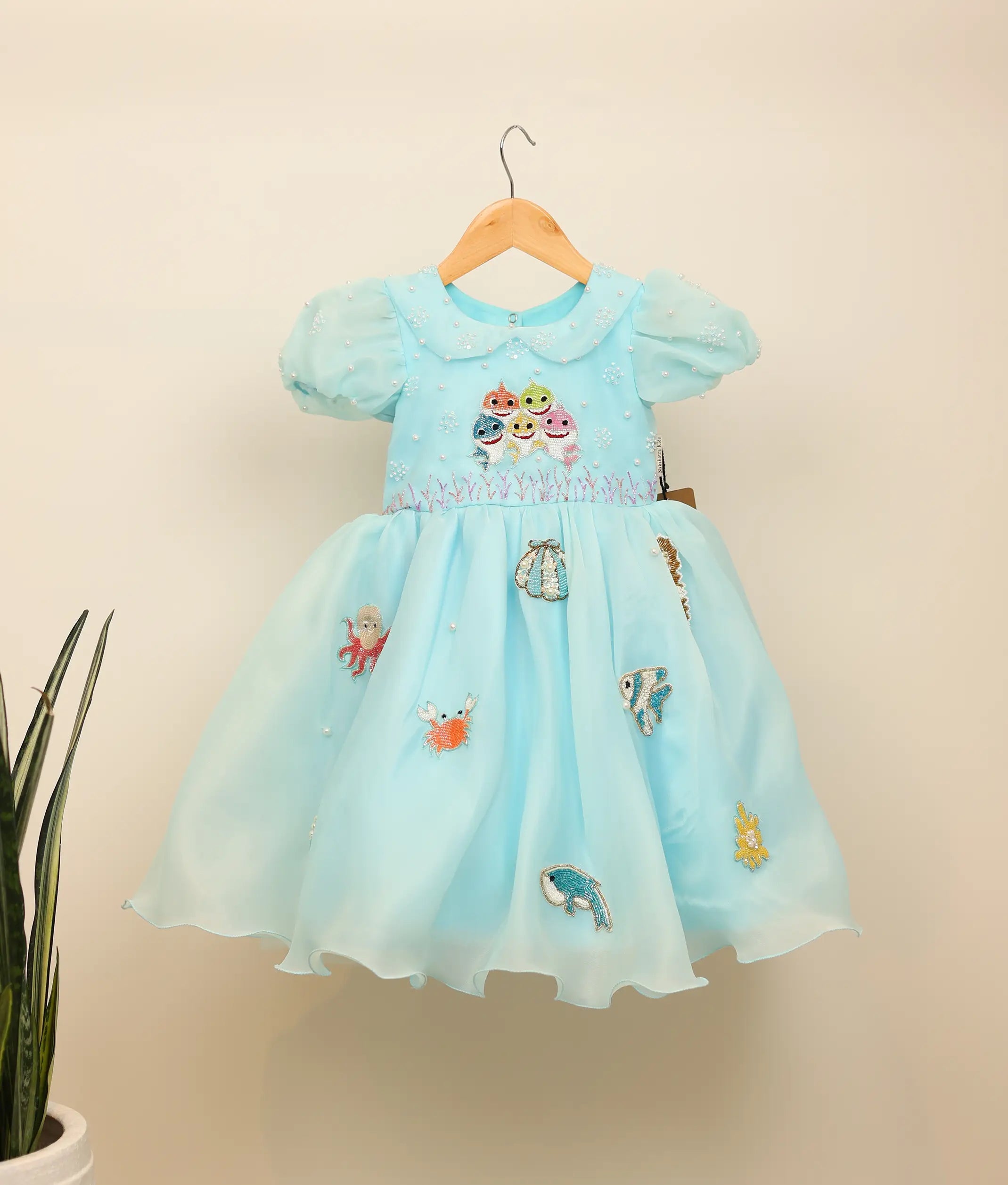 Front view of a sky blue Baby Shark theme birthday dress for girls with handworked characters and sea animals