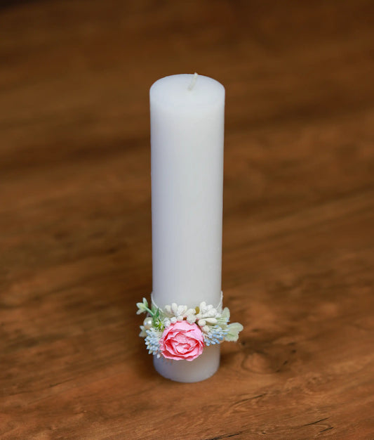 Close-up of the handcrafted pink roses, pearls, and sparkly beadwork on the decorative baptism candle