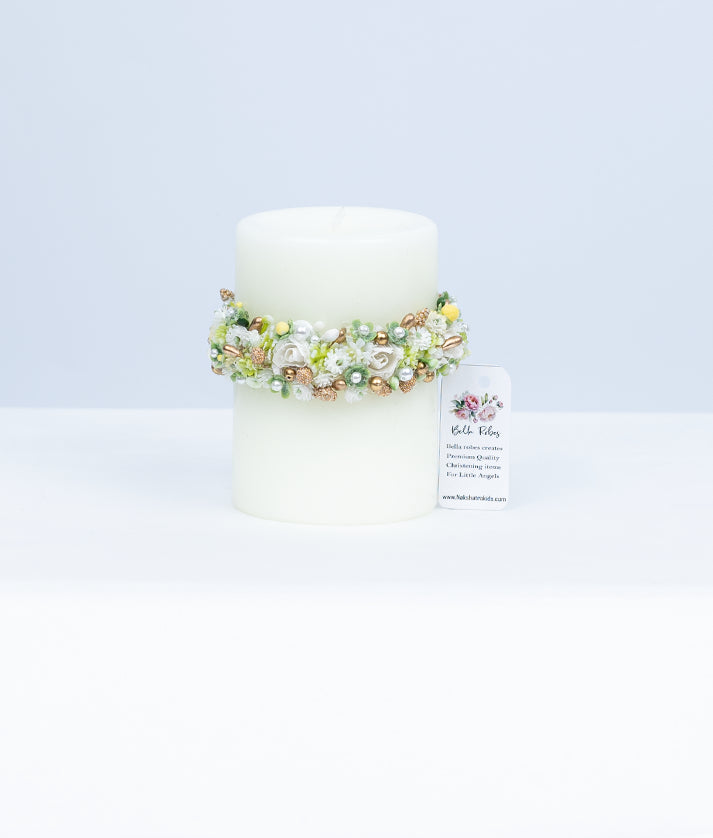 Close-up of intricate handworked lace and floral embroidery on a boutique designer baptism ceremony candle.