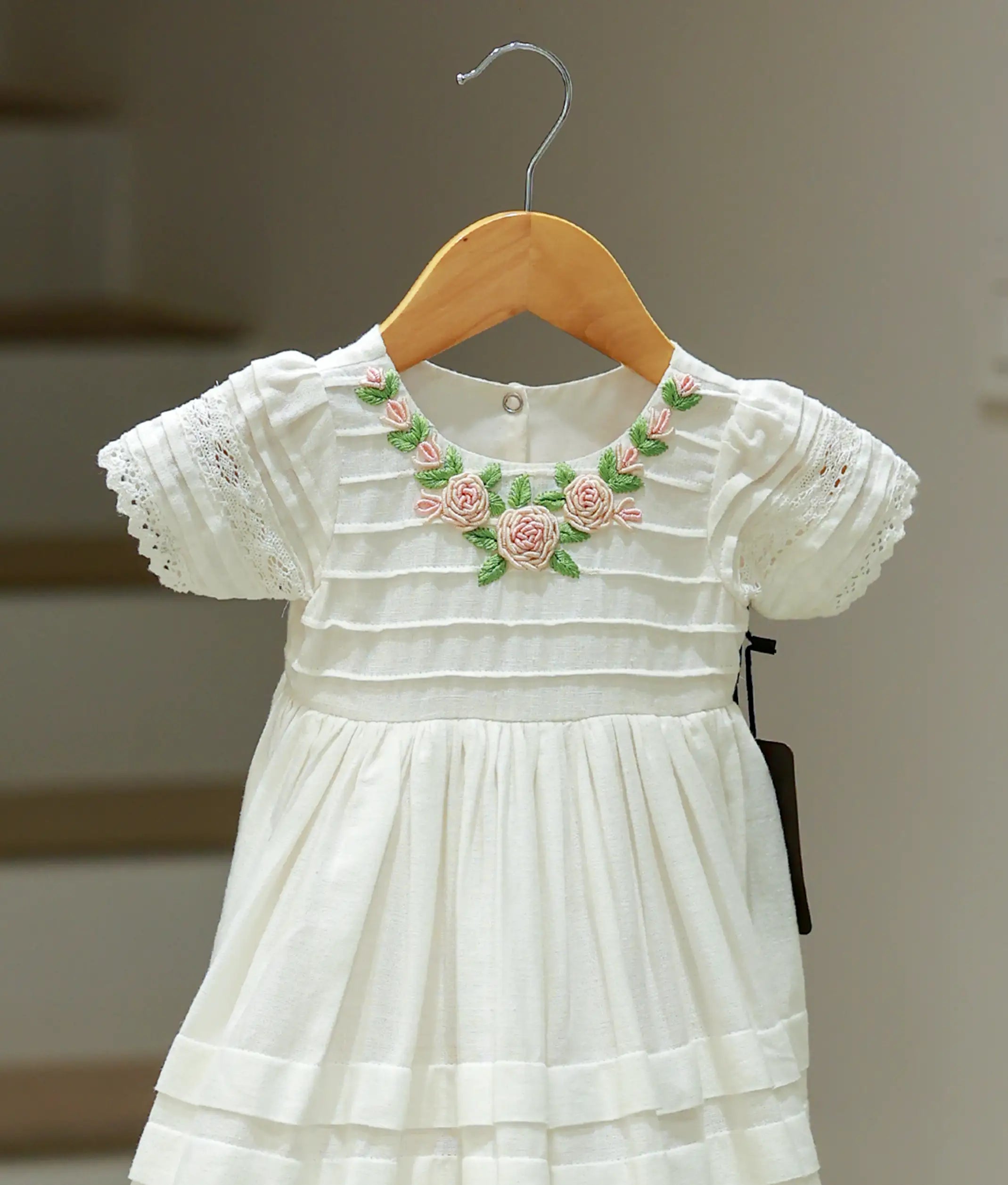 Close-up of the premium lace fabric and delicate embroidery on the baptism frock