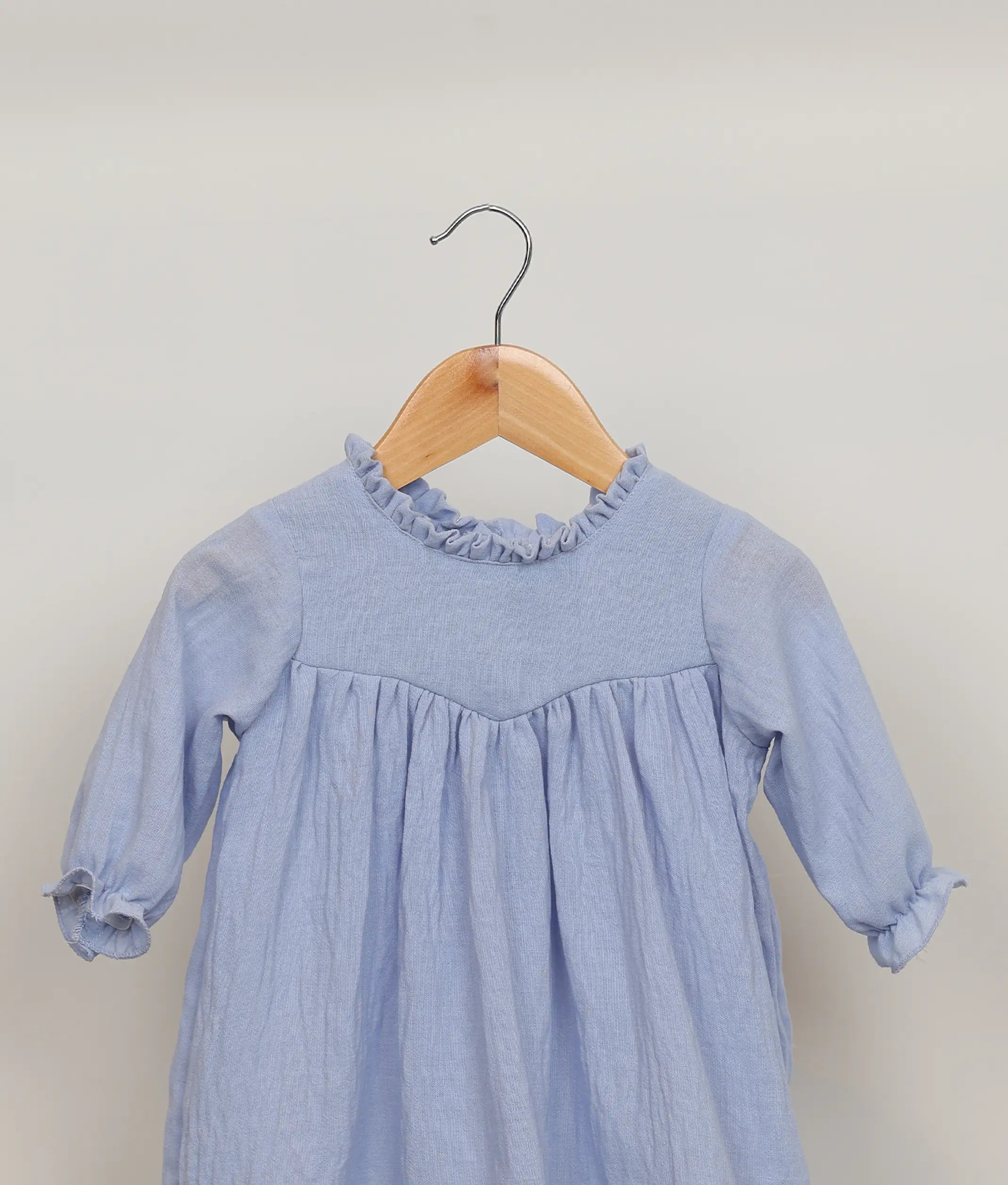 Close view of blue linen cotton casual frock for baby girl.