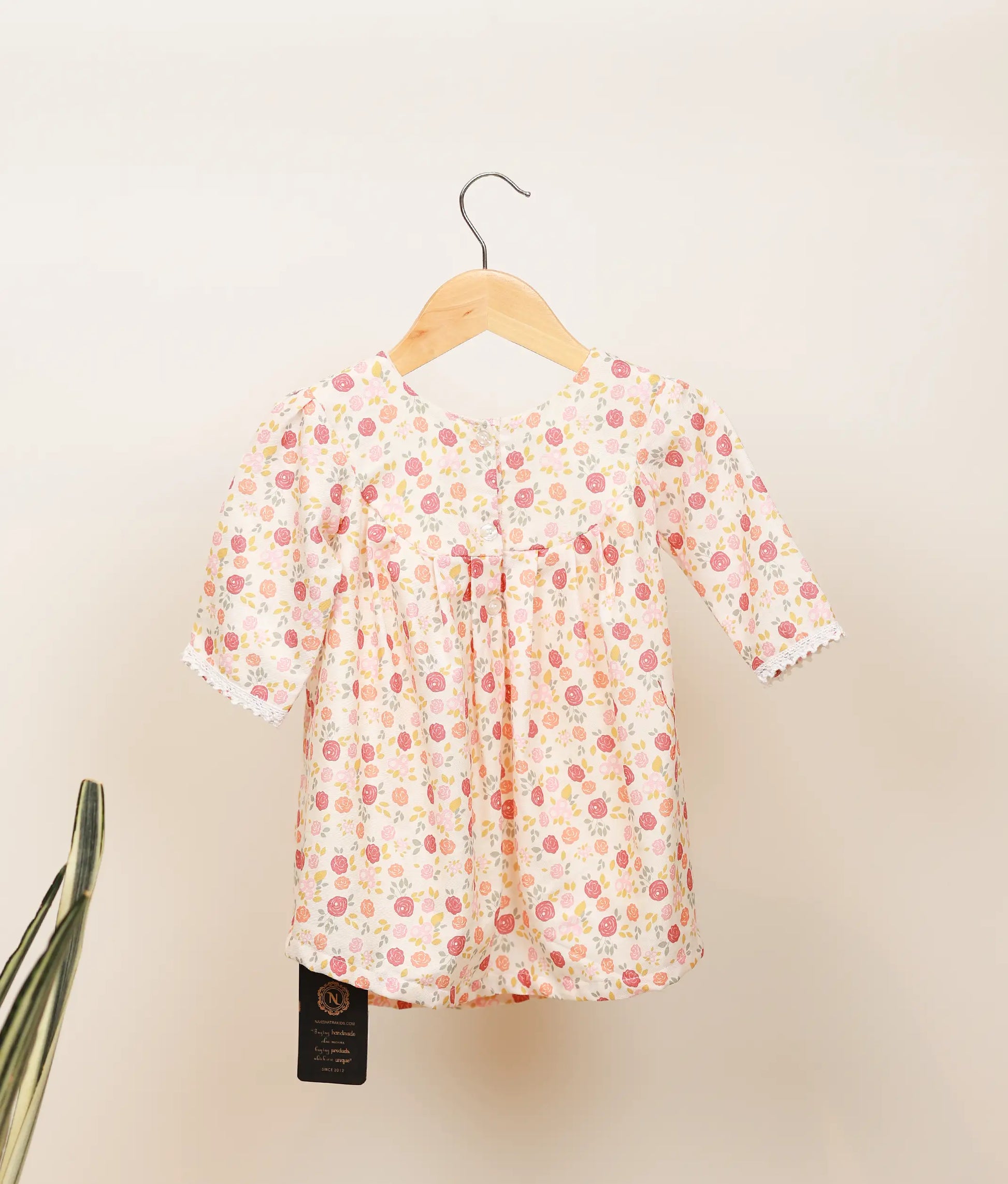 Back view of the below-knee, off-white dress showing the flared skirt and unique puff of the leg-o-mutton sleeves.