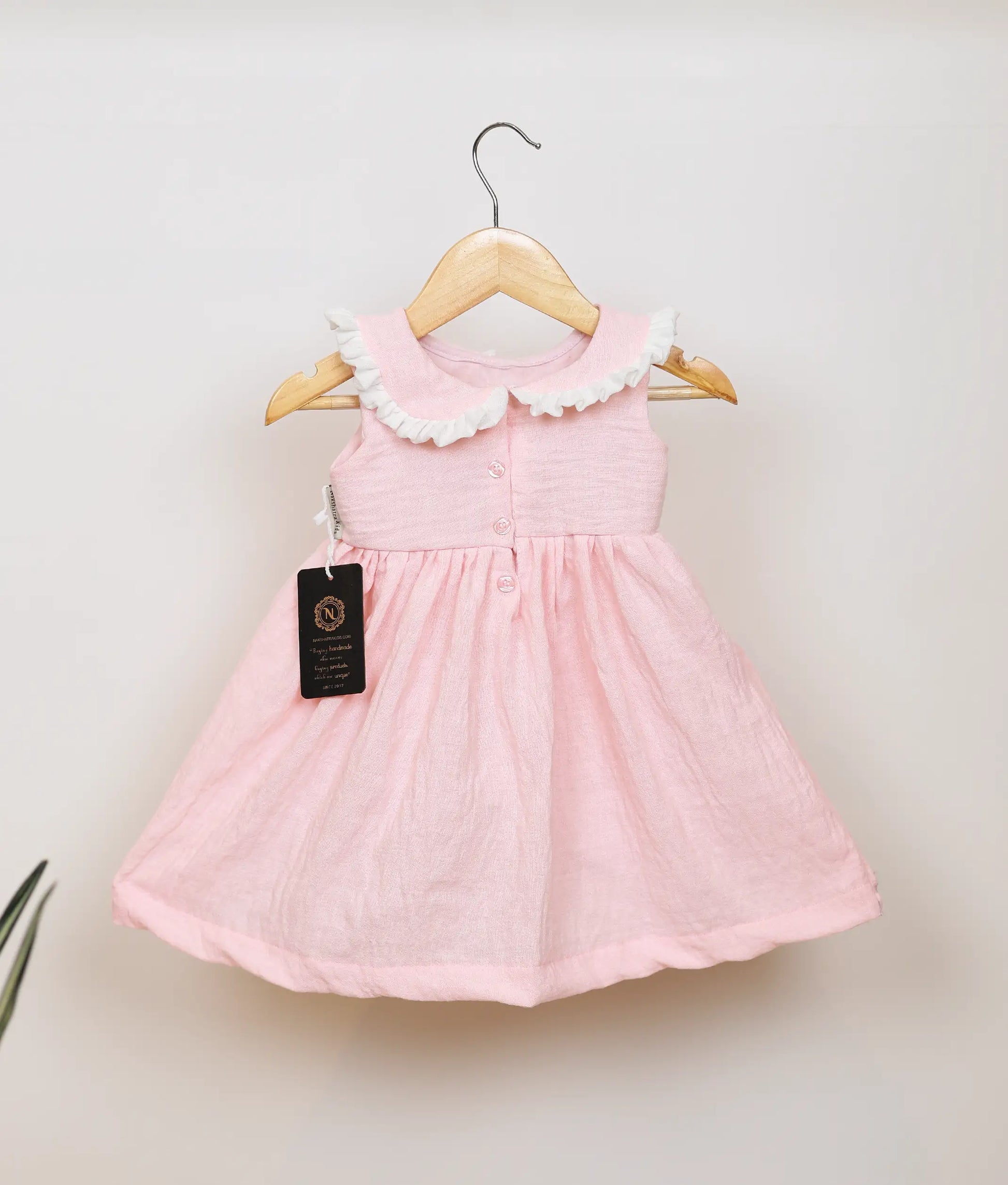 Back view of pink floral embroidery christmas frock for baby girl.