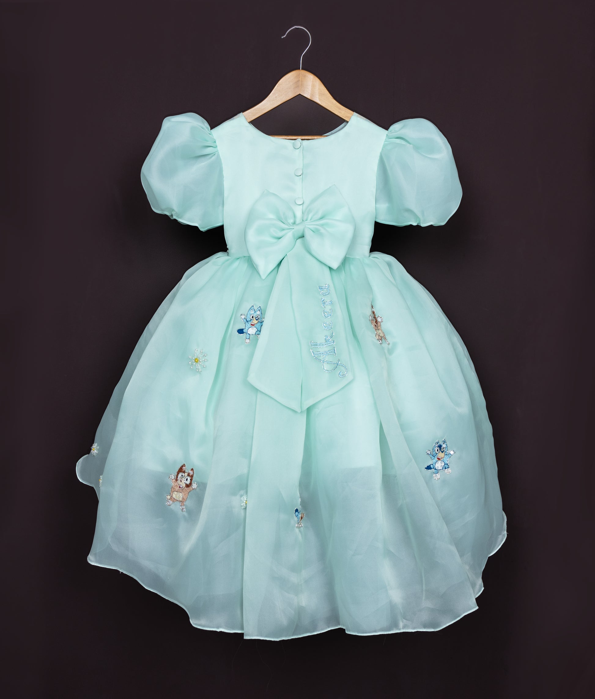 Frilly birthday frock for baby girl with pastel blue layers and flower appliques