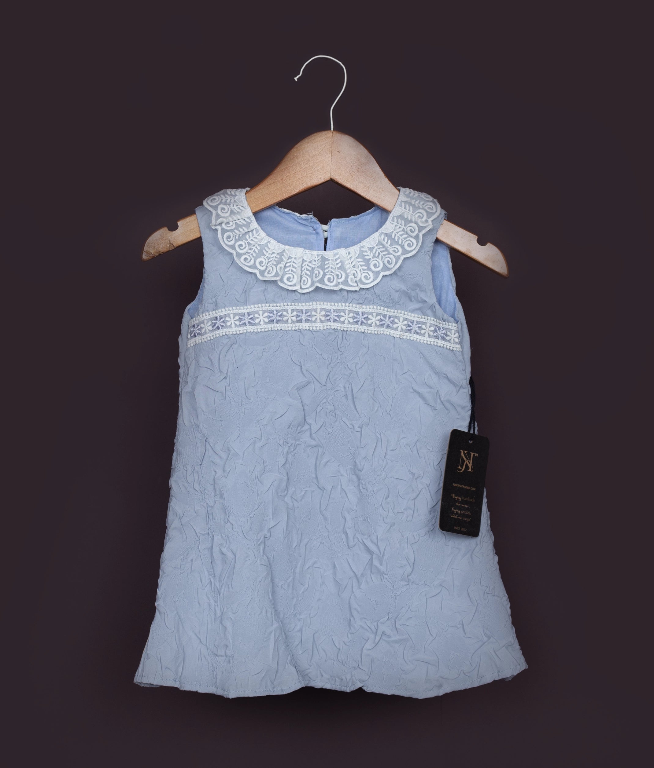 Sleeveless light blue birthday frock for baby girl with lace detailing