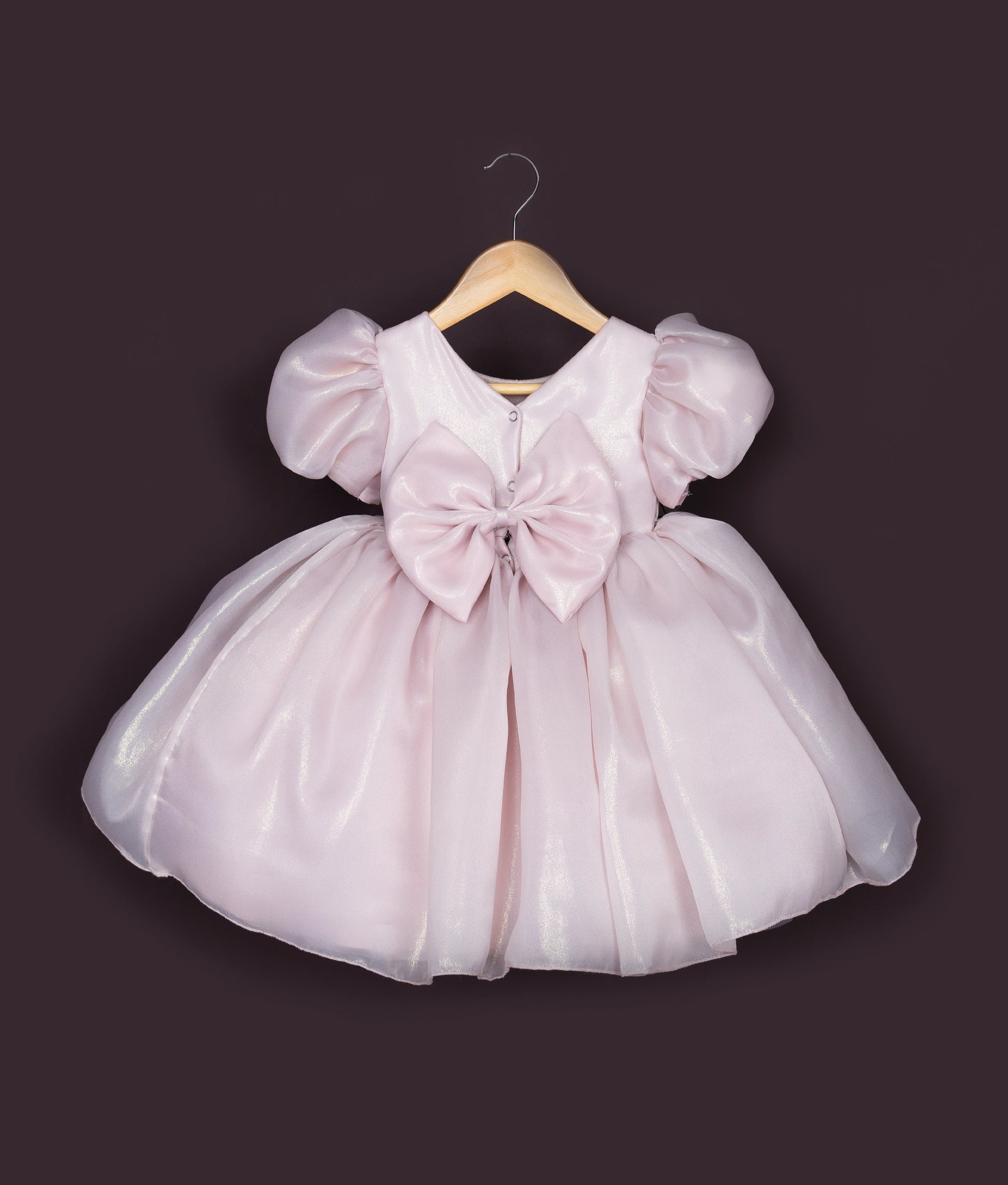 Cute baby girl birthday frock with frilly skirt and lace bodice in soft pink